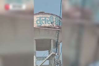 A young man climbed a tank