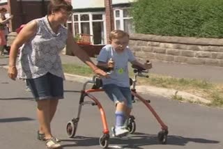 Boy with cerebral palsy finishes ginormous challenge as he raises 40,000