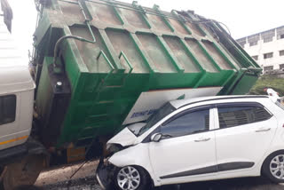 Garbage lorry trapped on the flyover divider after accident