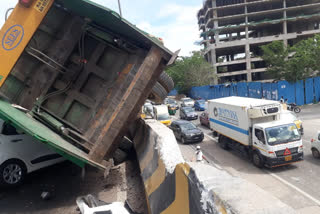 Garbage lorry stuck on the flyover divider after accident in Bengaluru