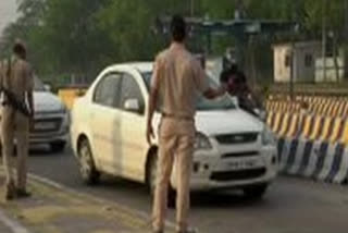 Police personnel screen vehicles at Delhi borders