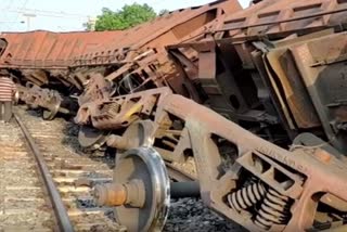 A freight train carrying overturned coal