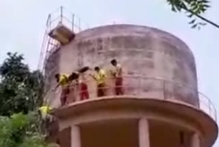 Mental illness man in a water tank threatens to commit suicide