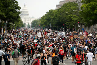 Demonstrators walk on Pennsylvania Avenue as they protest over the death of George Floyd.