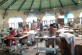 Women making PPE kits and masks