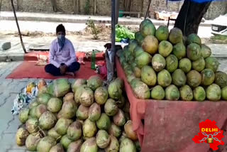 road side shopkeeper of coconut water still waiting for costumer durig unlock 1