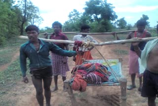 Villagers take the woman to the cot