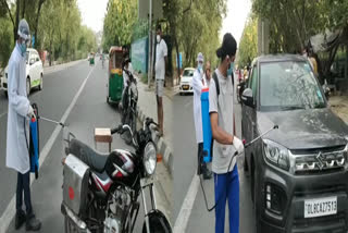 Two young men doing sanitation near RK Puram Red Light