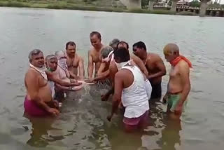 symbolic snan to sant dnyaneshwar mauli paduka in neer river