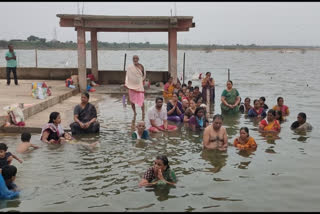 Devotees taken holy baths in  Godavari River at Mandhani