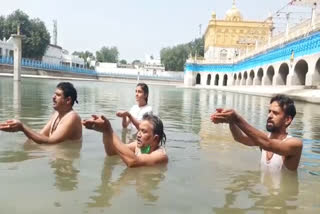 Amritsar: Devotees bathe in Durgiana temple during solar eclipse