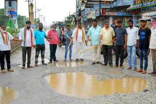 congress protest on burying potholes on roads at suryapet district