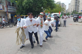 Congress protests by pulling car from rope in Noida as petrol and diesel prices rise