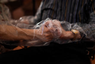 Dolores Reyes Fernández holds the hands of her father José Reyes Lozano for the first time in nearly four months as visits resume to a nursing home in Barcelona, Spain.