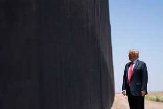 Trump scrawls signature on border wall in Arizona