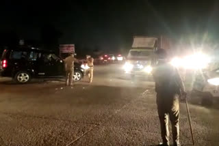 Police checking vehicle during night