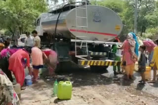 people violating social distancing during filling water from tanker