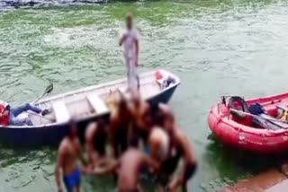 Diver carrying the dead body of a young man