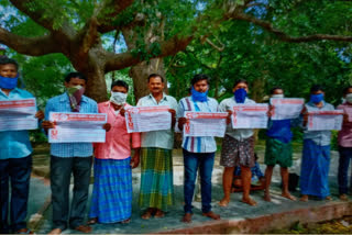Wall posters release for building workers' strike at narsipatnam in visakhapatnam district