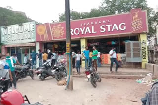 Youths beat beggar outside liquor shop