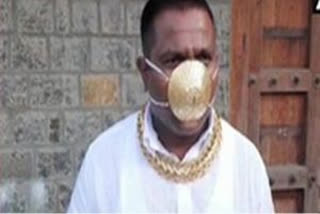 Man donning gold mask