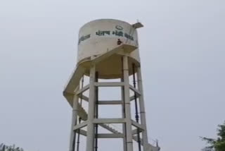 Woman climbs on water tank against market committee chairman in fatehgarh sahib