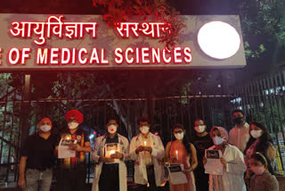 aiims doctors gives tribute to corona warriors by proceeding candle march at campus