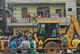 cleaning staff houses demolished at east laxmi market in delhi