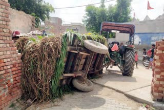 A tractor hits the wall of the house in Gannaur