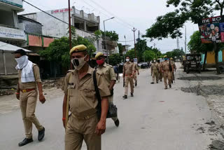 Police flag march on the second day of the lockdown in Mau