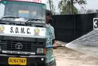 sanitization work outside Sardar Patel covid Care Center in delhi