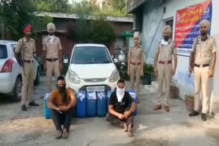 Dhariwal police arrested a Punjab police constable and his accomplice with illicit liquor