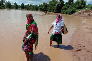 Women health coordinator crosses river