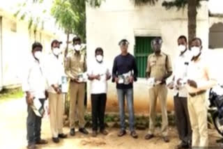 ex-zptc distributed masks and face shields to police at dubbaka in siddipet district