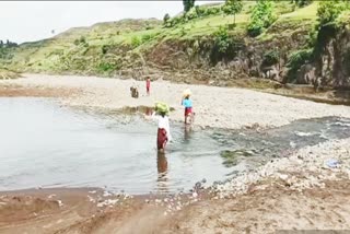 Villagers crossing the river