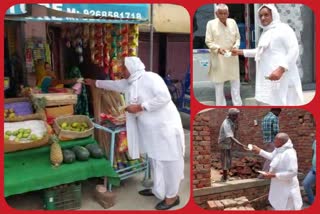 BJP workers distribute packets of Ayush decoction in Ujwa village of Najafgarh