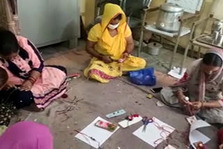 Women making rakhis