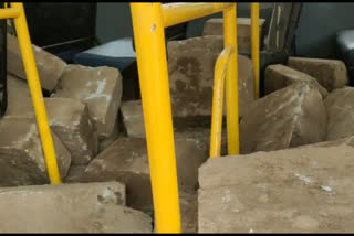 A bus carrying stones