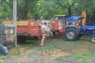 police raided and seized the JCB machine, a truck and four trolleys filled with sand