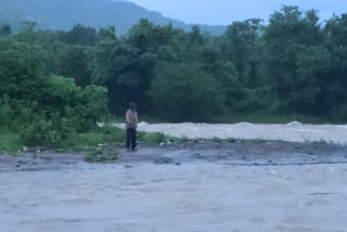 rescuing 3 people trapped in the flood in Raigad