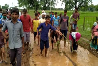 Villagers sowing paddy on the road