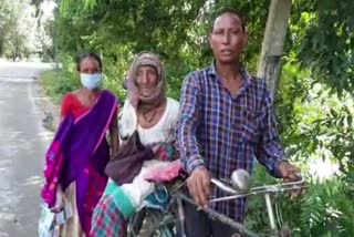 poor-road-impact-son-carrying-his-patient-mother-in-bicycle