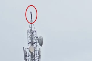 A young man climbed a mobile tower