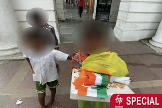 Children selling flags at traffic lights and bus stops on 15 August