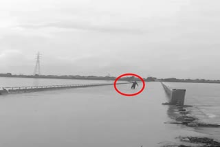 drunkned man crossed bridge which is filled with water