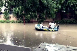 gurugram people doing boating on water logged road in the city