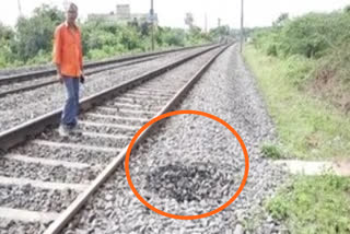 Pit formed next to the track near Mahabubabad railway station.