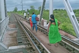 People forced to travel by railway track