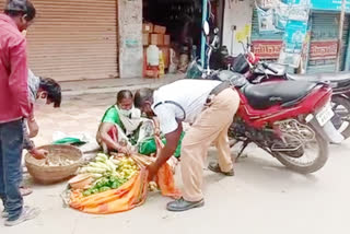 Traffic police removing vegetables at nizamabad