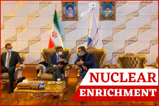 Director General of International Atomic Energy Agency, IAEA, Rafael Mariano Grossi, center, listens to spokesman of Iran's atomic agency Behrouz Kamalvandi upon his arrival at Tehran's Imam Khomeini airport, on Monday.